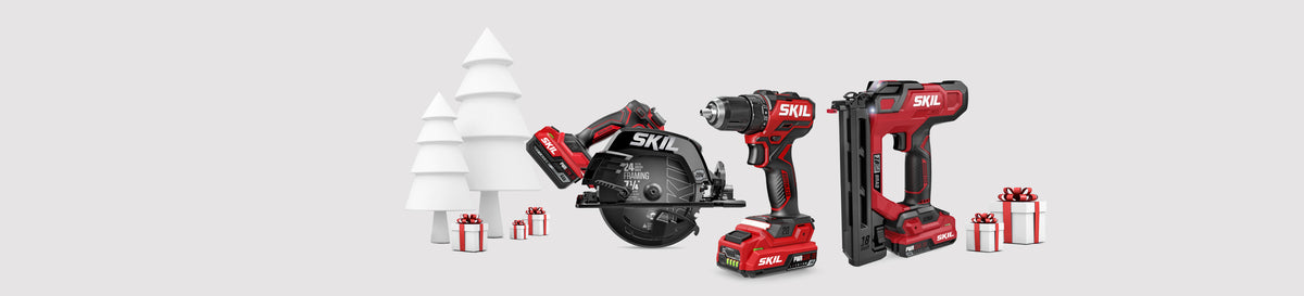 A selection of SKIL power tools surrounded by holiday gifts with a stylized white tree in the background