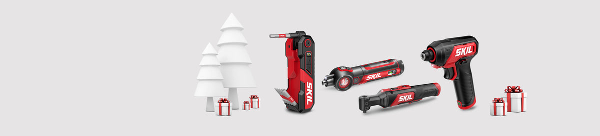 A selection of smaller SKIL power tools surrounded by holiday gifts with a stylized white tree in the background