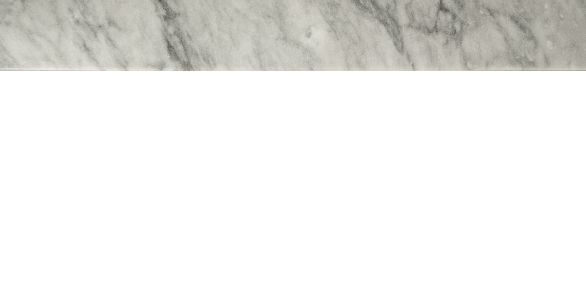 A close-up of a white marble surface with gray veining.