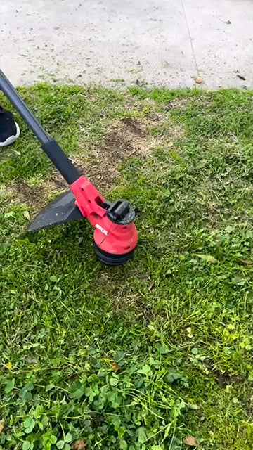The SKIL 40V 15 In. String Trimmer trimming grass.